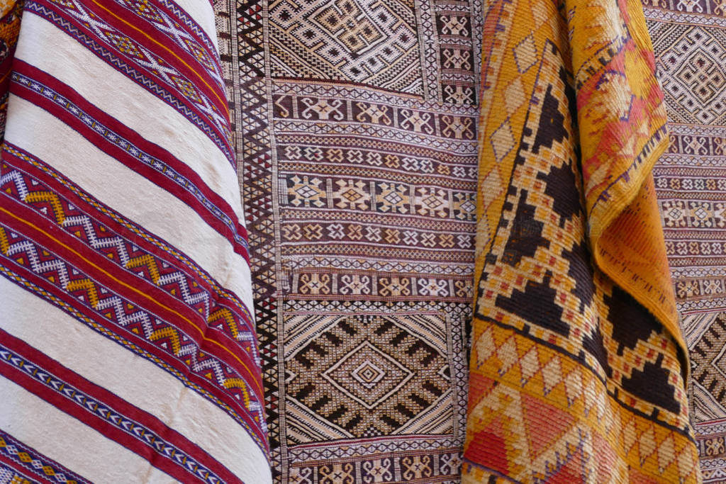 Bright colored patterns on throw rugs in the medina bazaar