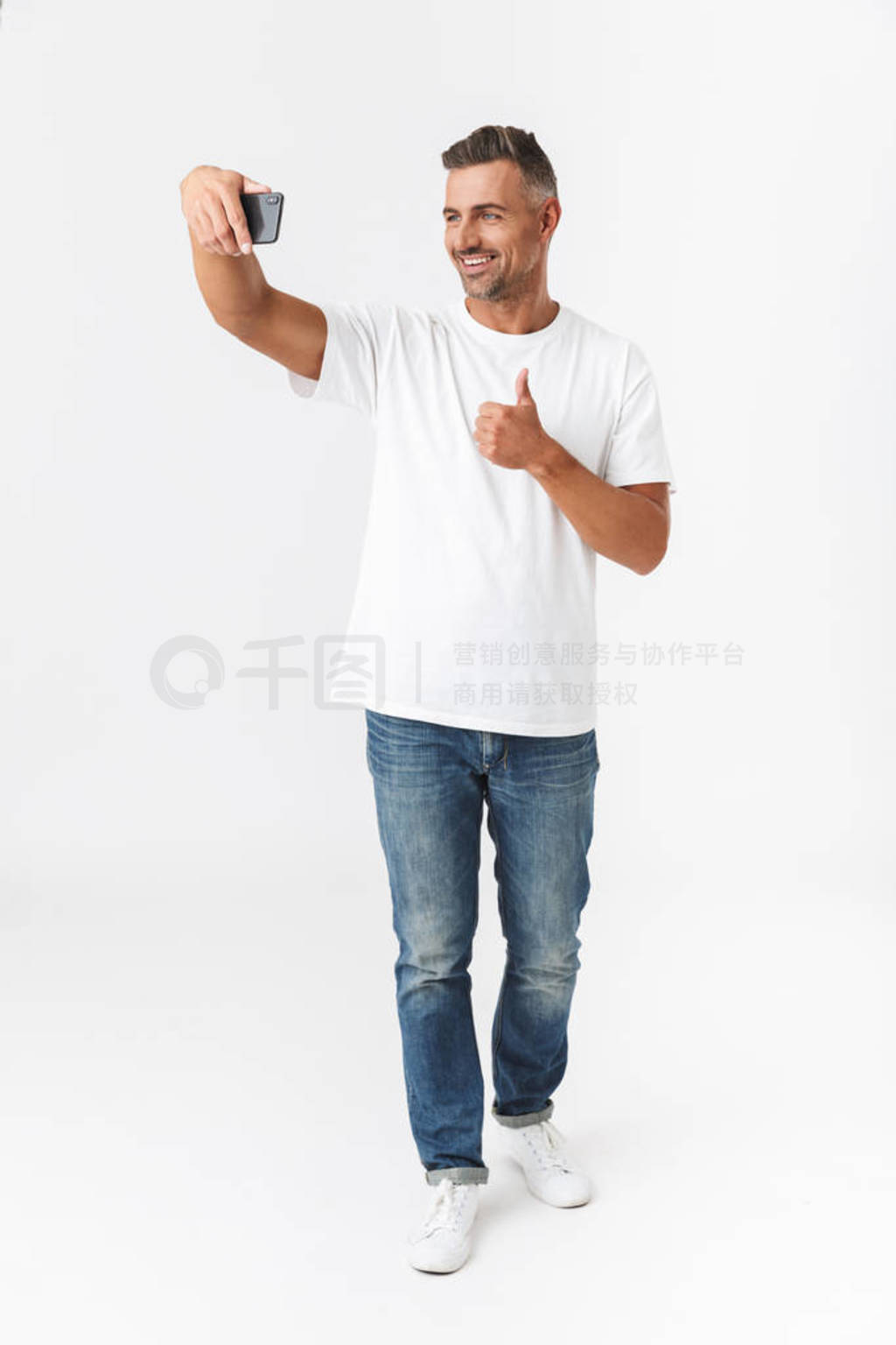 Full length image of smiling man 30s wearing casual t-shirt and