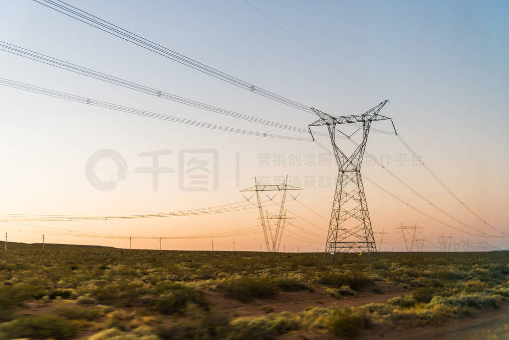 Electricity power tower line pylons at the sunrise.
