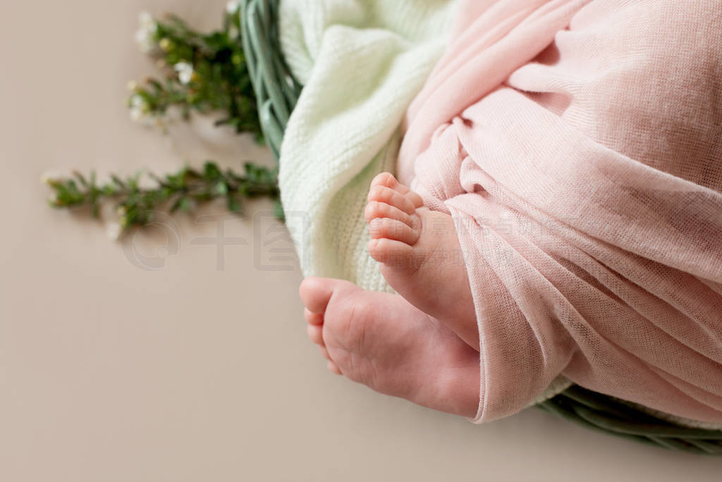 feet of the newborn baby with flower, fingers on the foot, mate