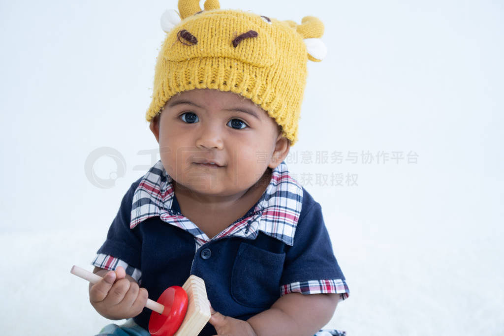 Cute little asian baby boy sitting and play toy
