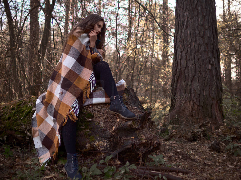 Woman in a plaid in the forest. Autumn Walk.
