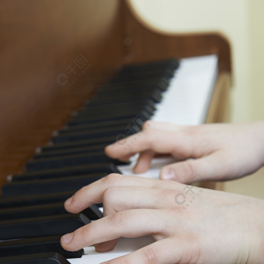 弹钢琴的孩子的手的特写