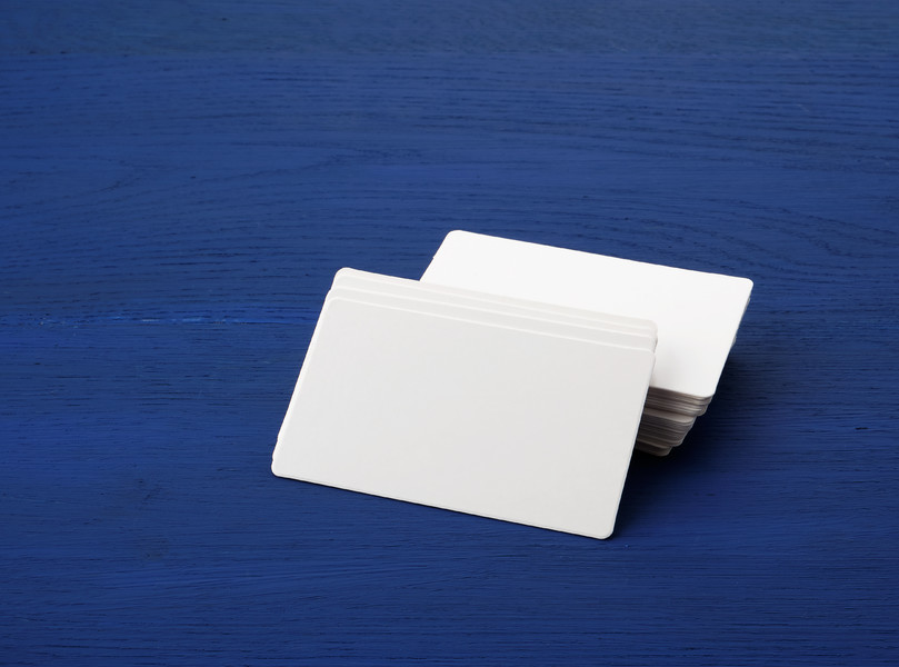 01蓝色木质背景上的一堆白色空白纸矩形名片,设计师模板000木制背景上