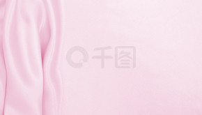 光滑优雅的粉红色丝绸或缎面质地可用作婚礼背景。豪华背景设计