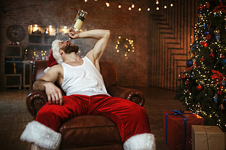 坏圣诞老人喝酒，讨厌的聚会。不健康的生活方式，穿着节日服装的大胡子男人，新年酗酒。坏圣诞老人喝酒，讨厌的派对