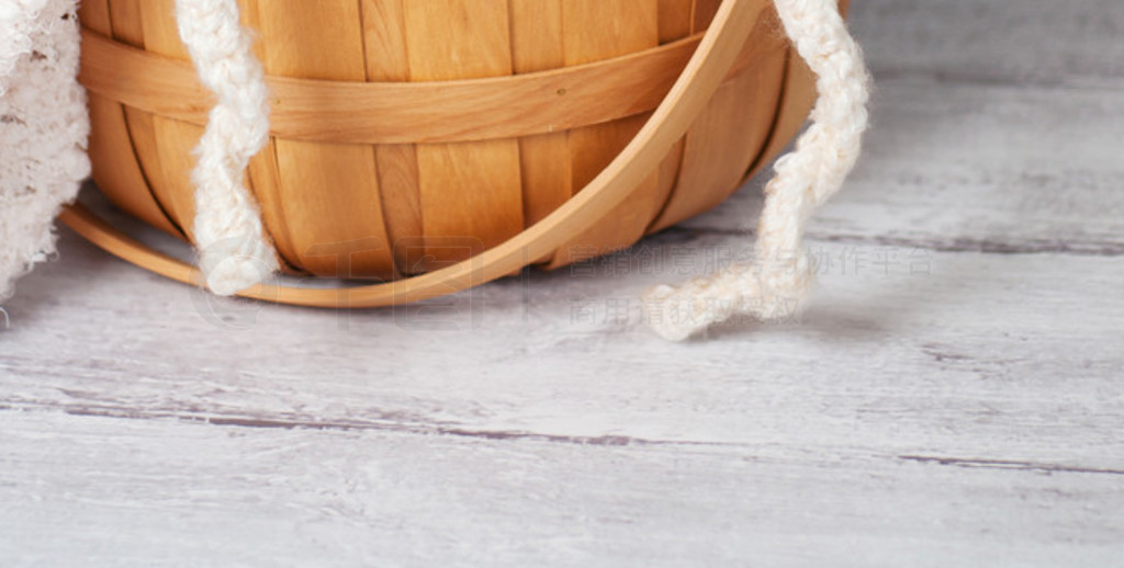 Newborn girl wearing a crocheted lamb hat and sitting in a basket