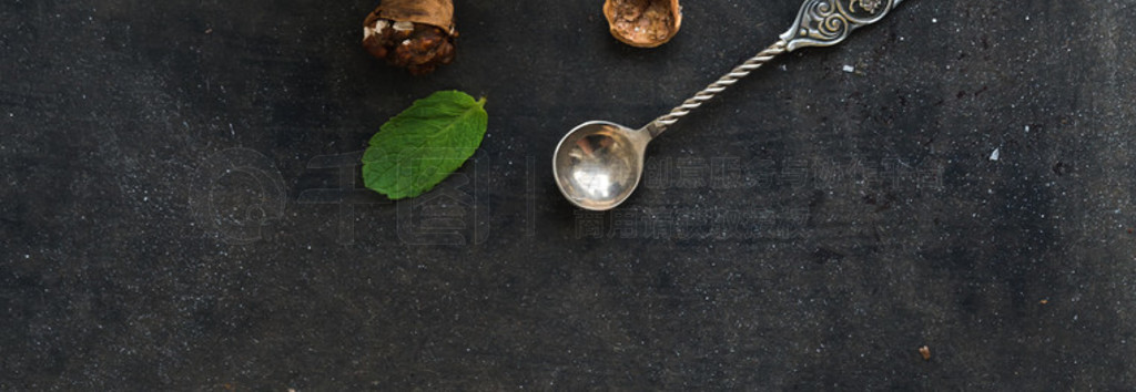 Walnut and salted caramel ice-cream in glass jars with fresh mint over dark grunge backdrop, top vie