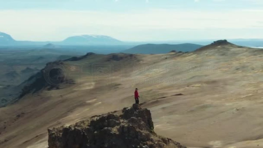 Man Traveler Stands on Mountain Top. Iceland. Aerial View