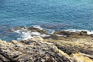 湛蓝色的海洋白色的<i>浪</i><i>花</i>拍打着岩石惊涛拍岸