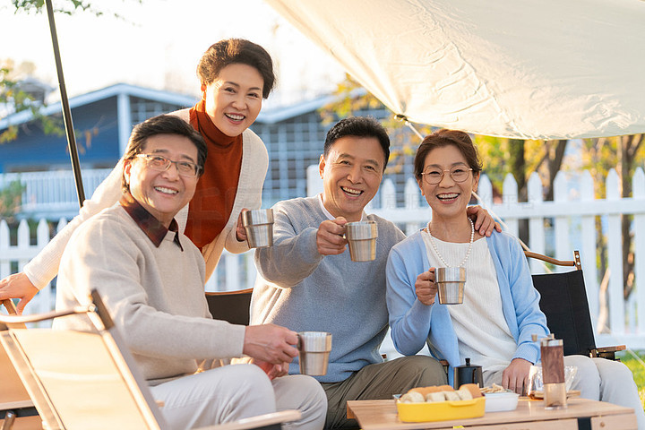 一群中老年人露营地喝咖啡聊天