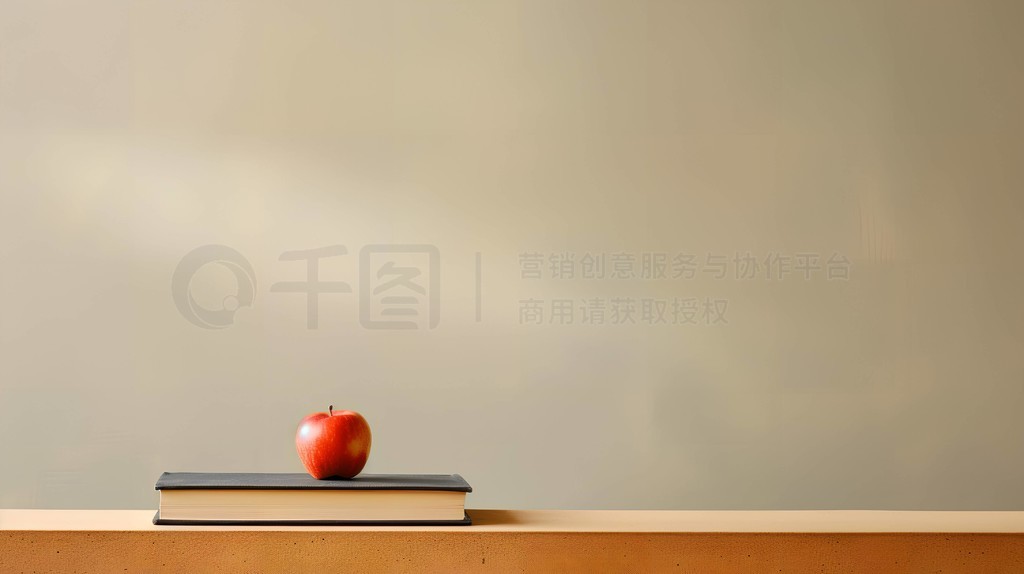 一摞书上放着一颗苹果教育理念ppt背景摄影图