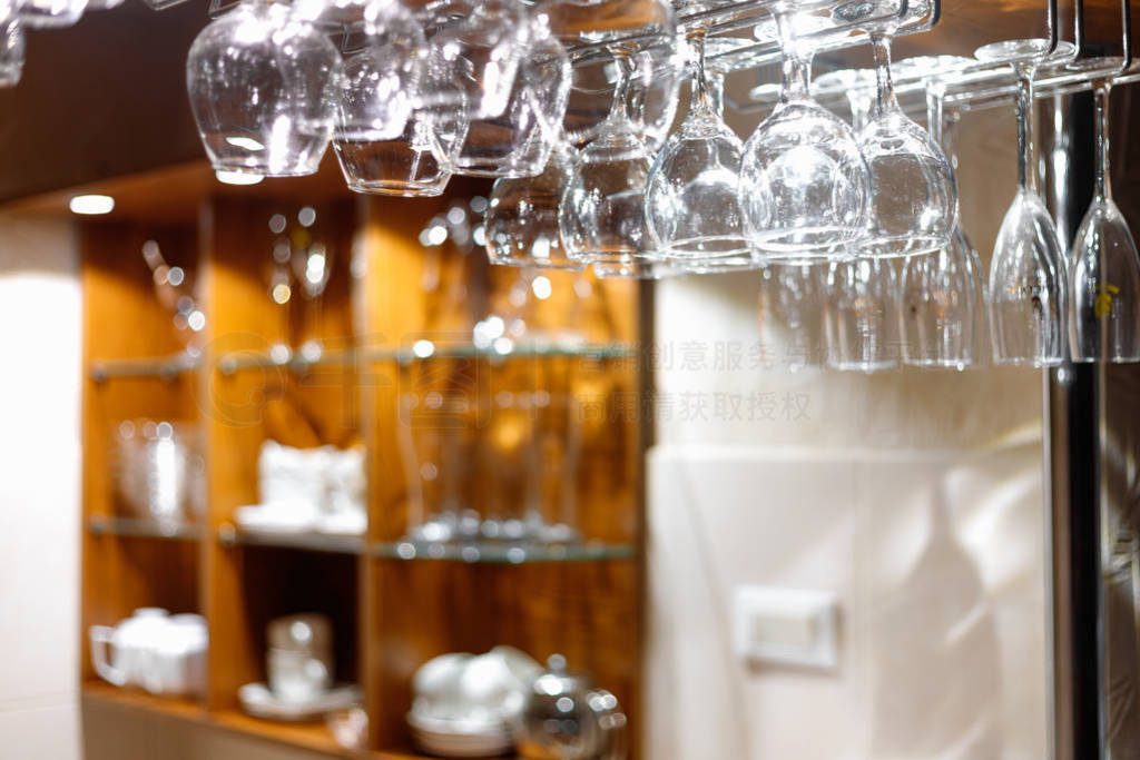 Empty glasses hanging above the bar in the restaurant.