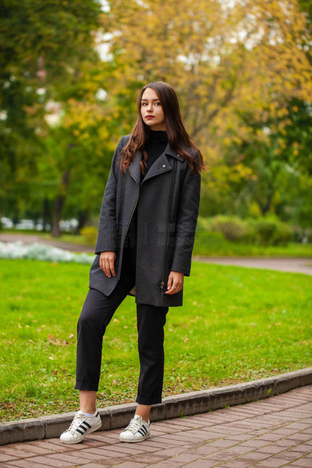 Portrait of a young beautiful woman in gray coat