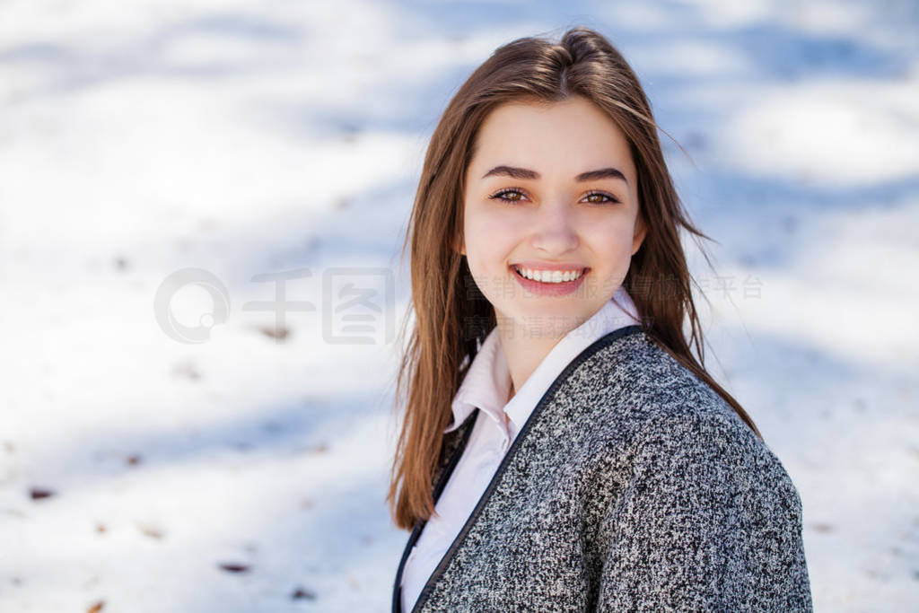 Close up. Young beautiful brunette girl in gray coat