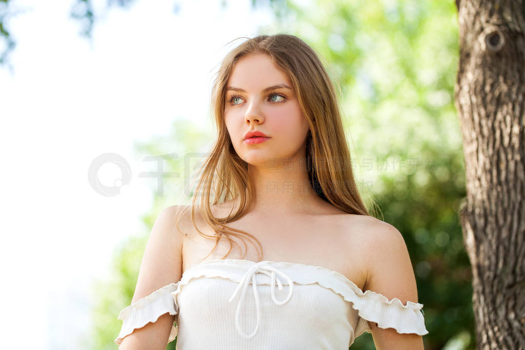 Young beautiful blonde girl with bare shoulders