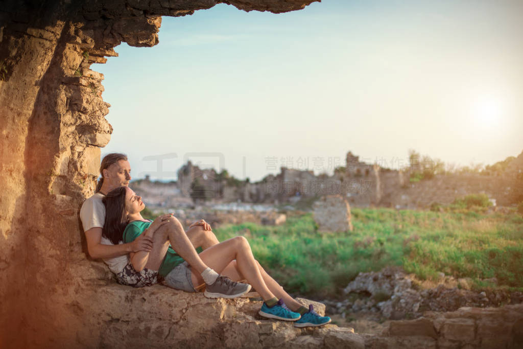 Embracing couple on the ancient Greek ruins background. Manavgat
