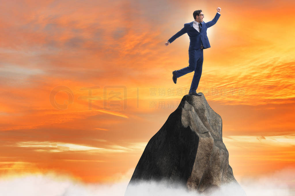 Businessman at the top of mountain