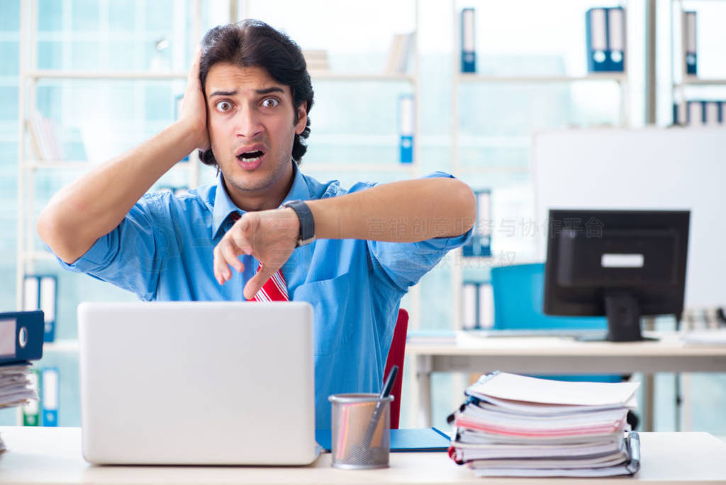 Handsome businessman unhappy with excessive work in the office