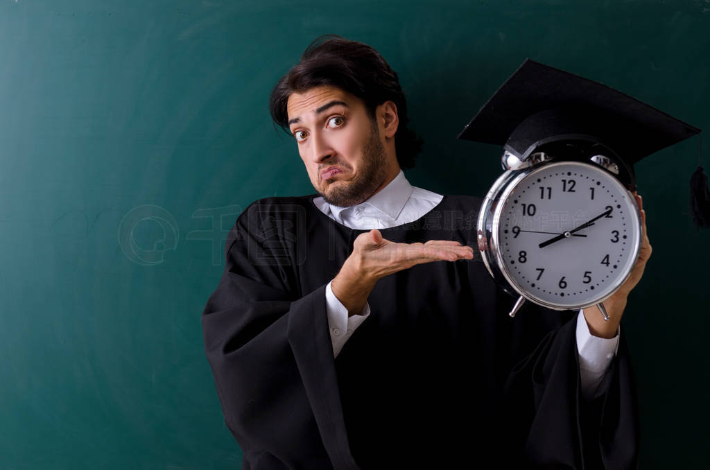 Graduate student in front of green board