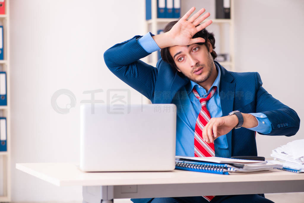 Young handsome businessman sitting in the office