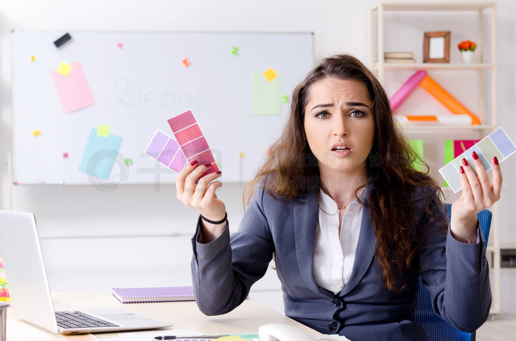 Young female designer working in the office