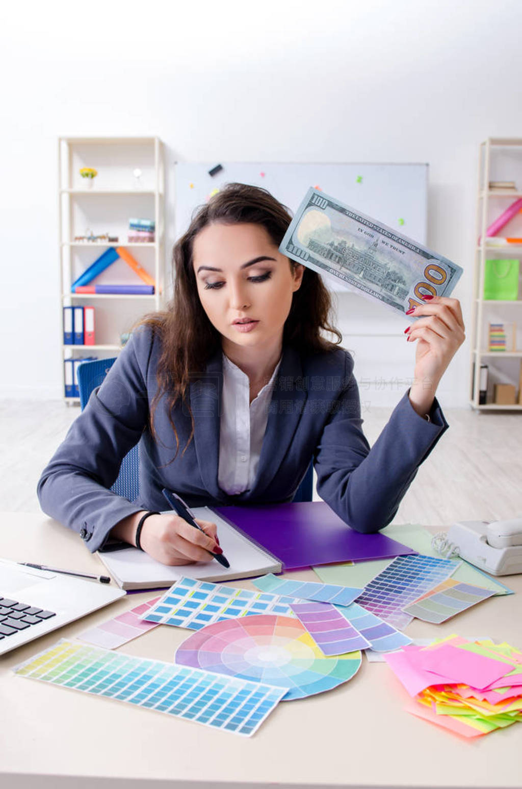 Young female designer working in the office