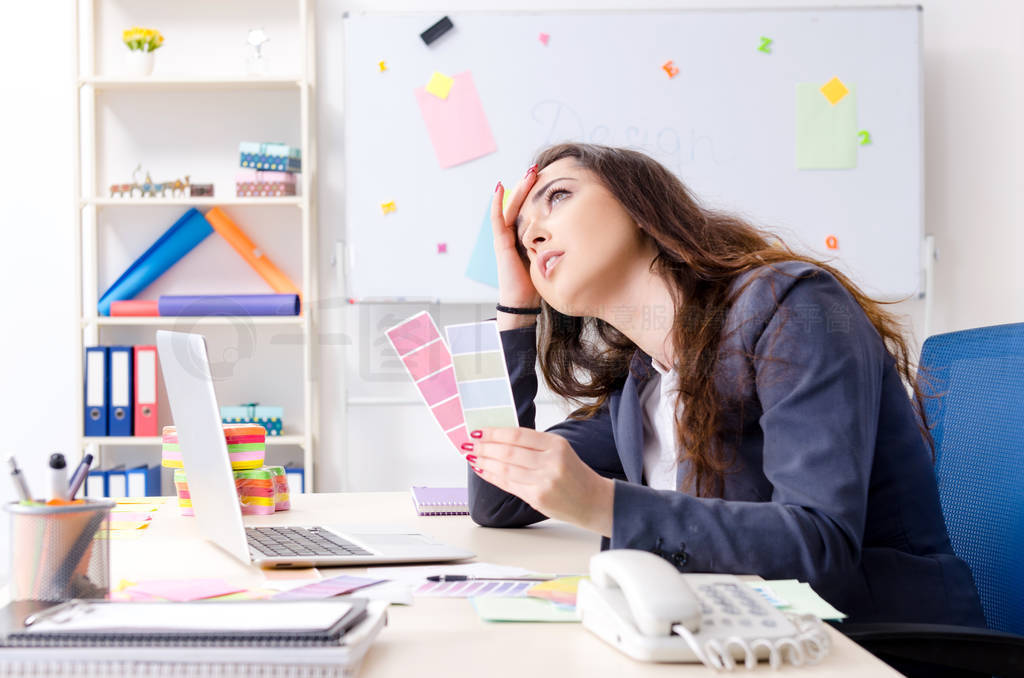 Young female designer working in the office