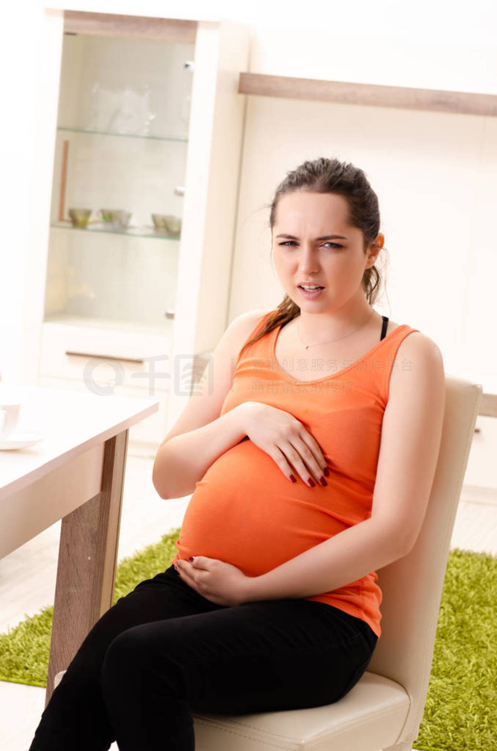 Young pregnant woman working at home