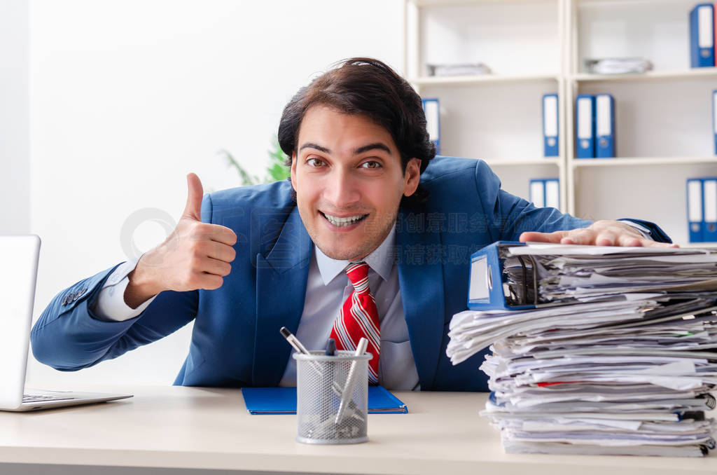 Young happy male employee in the office