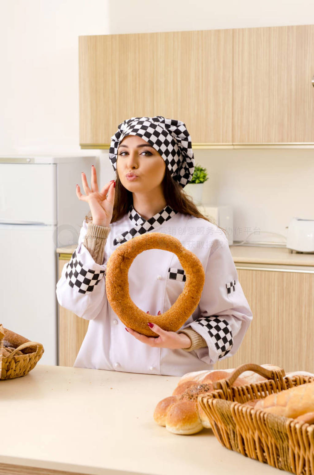 Young female baker working in kitchen