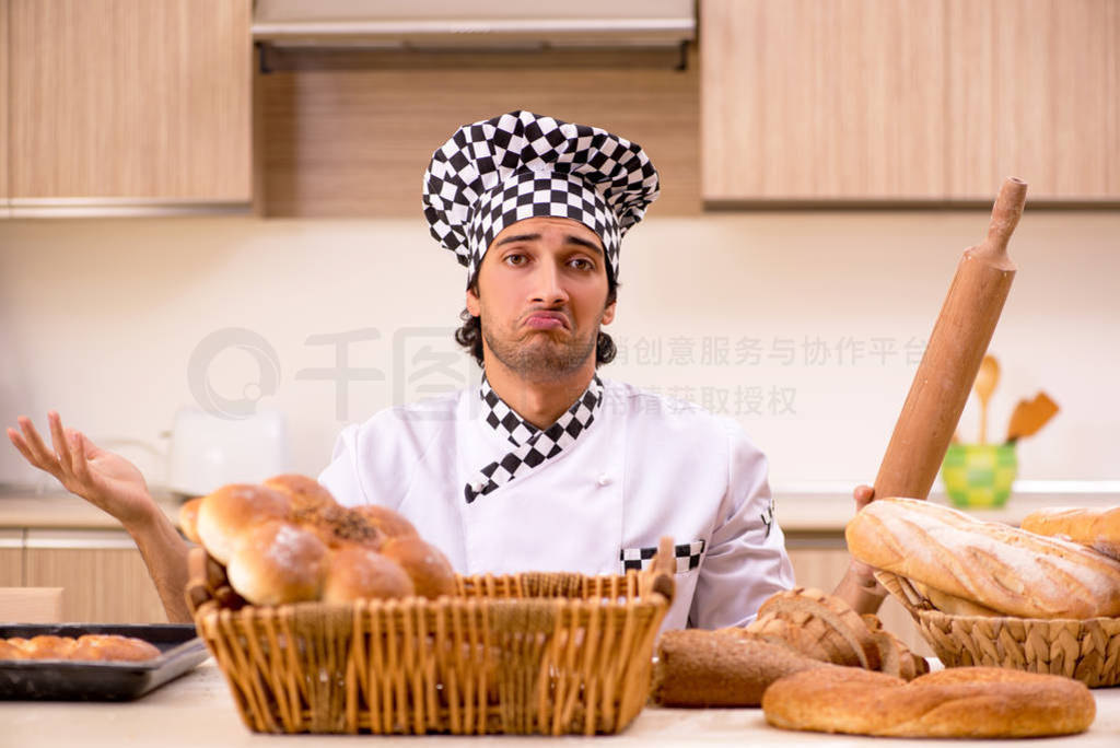 Young male baker working in kitchen