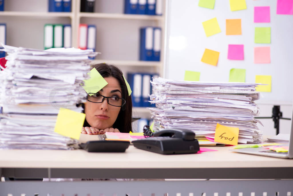 Young female employee in conflicting priorities concept