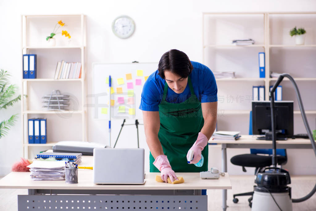 Male handsome professional cleaner working in the office