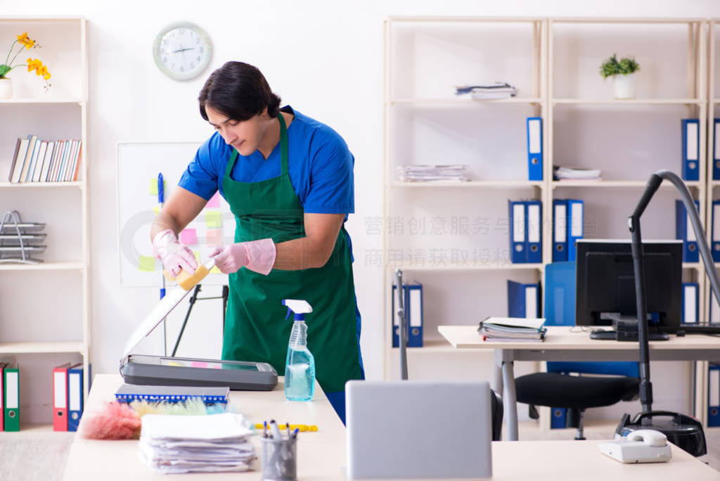 Male handsome professional cleaner working in the office