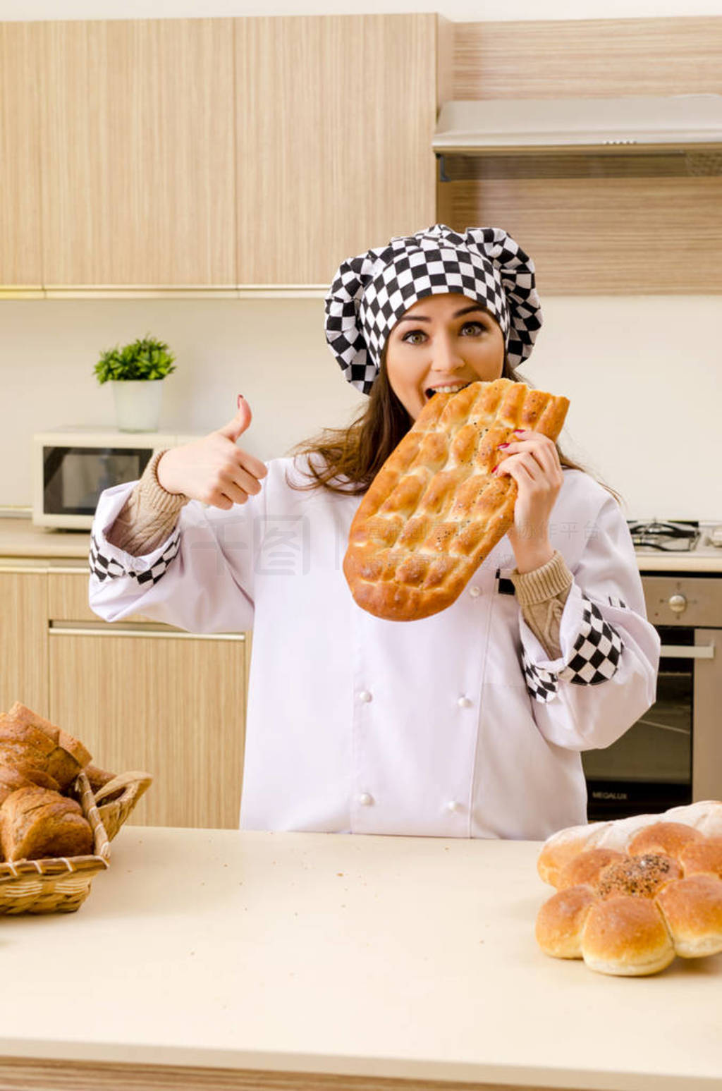 Young female baker working in kitchen