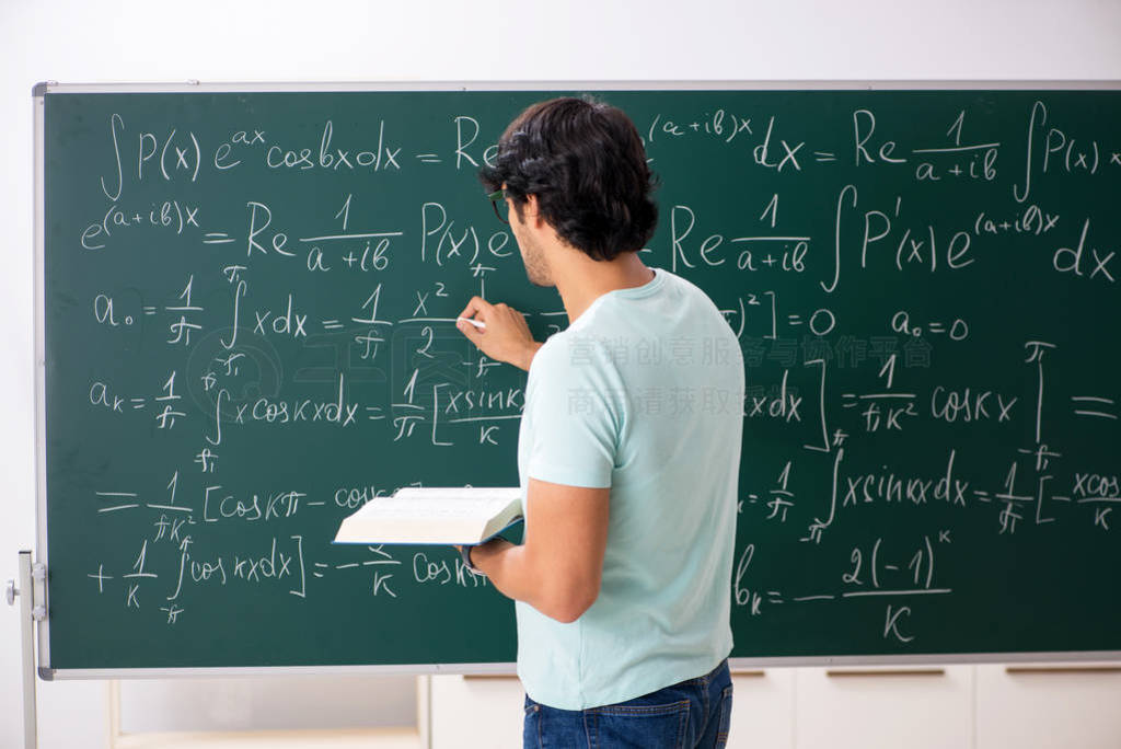 Young male student mathematician in front of chalkboard