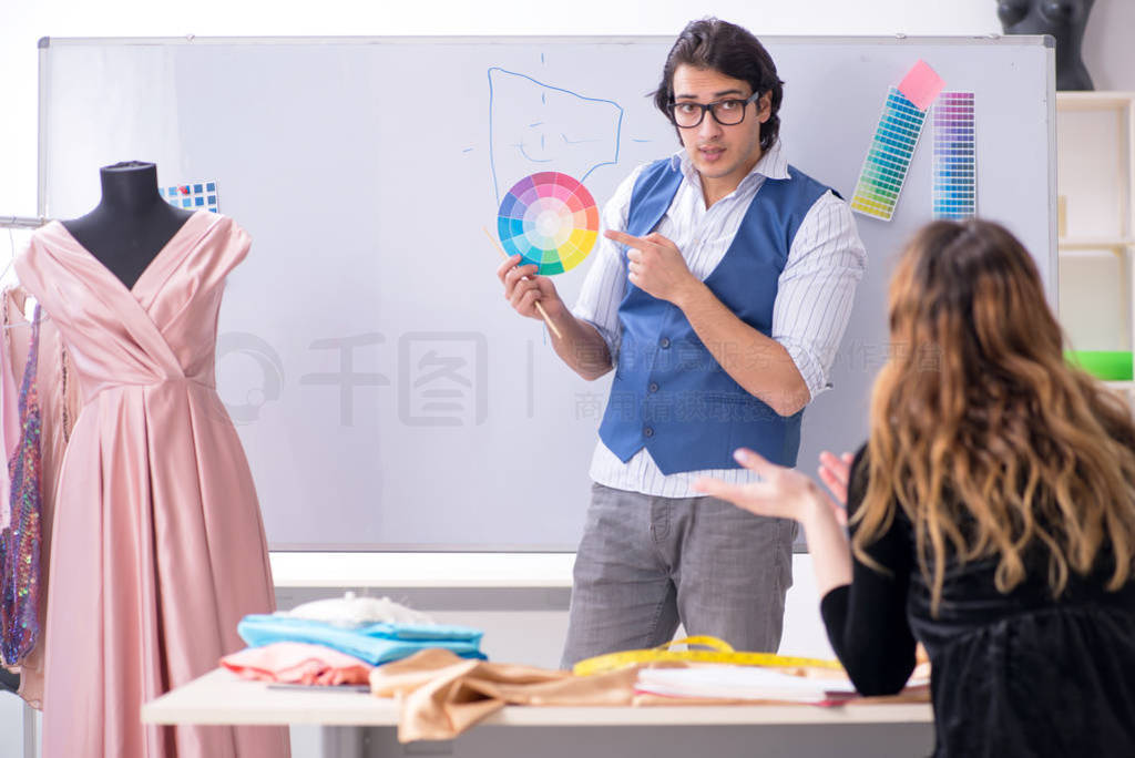 Young male tailor teaching female student