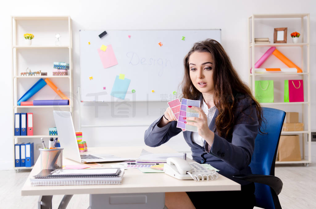 Young female designer working in the office