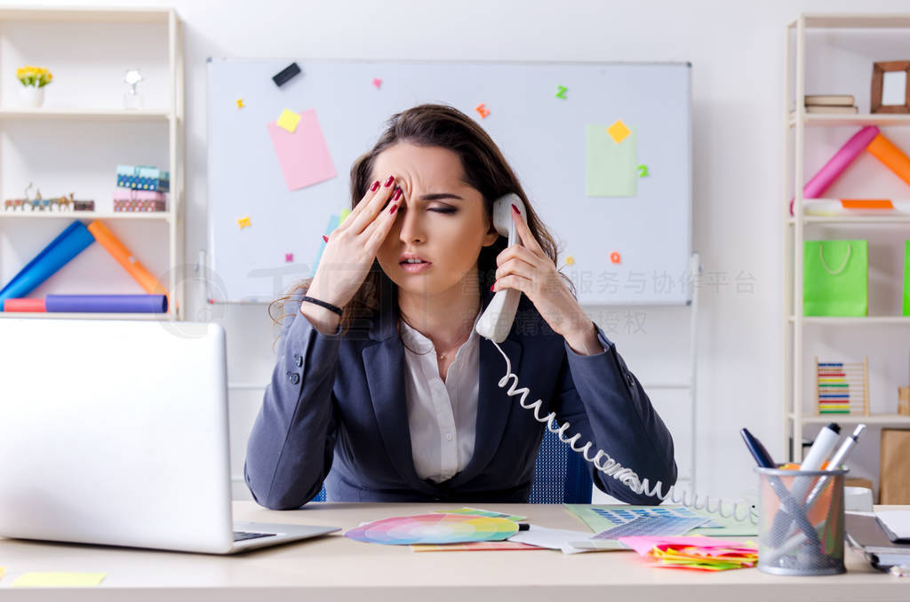 Young female designer working in the office