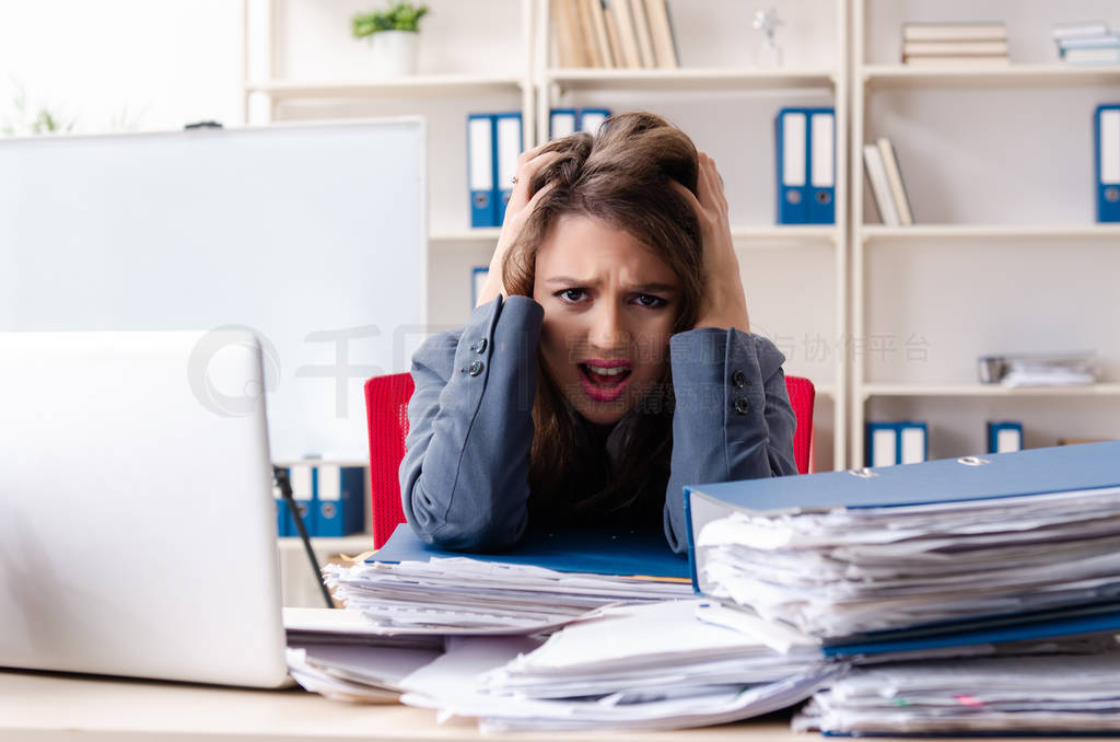 Beautiful female employee unhappy with excessive work