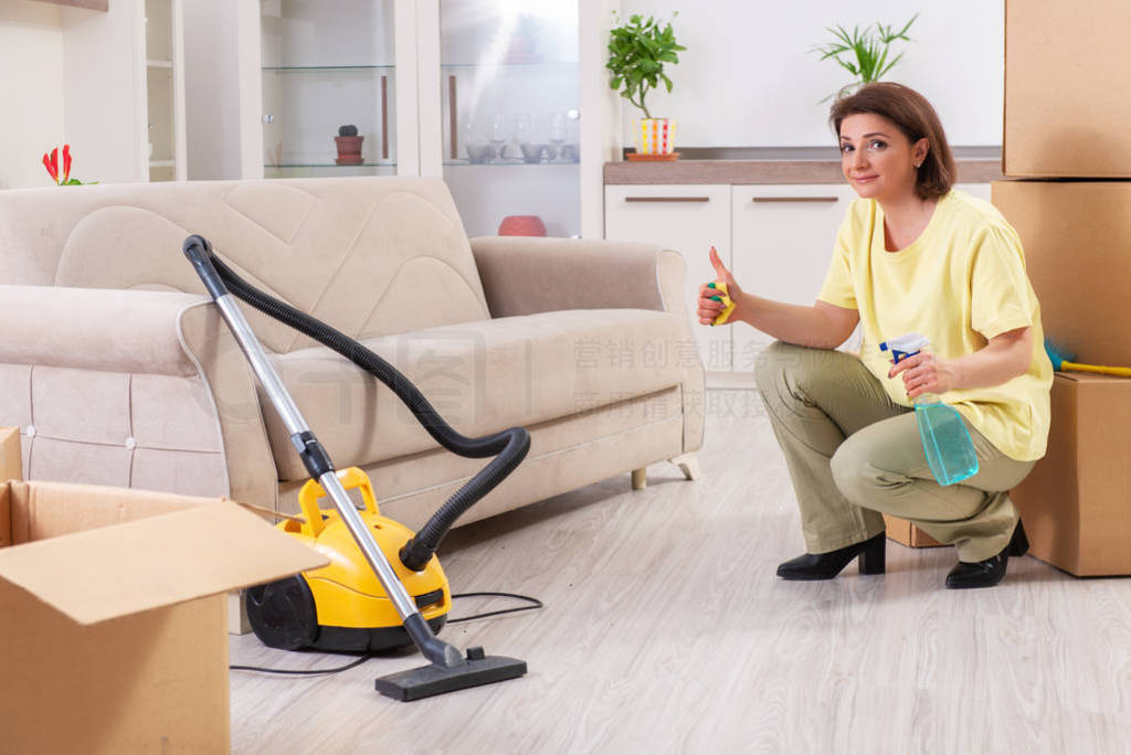 Middle-aged woman cleaning new apartment