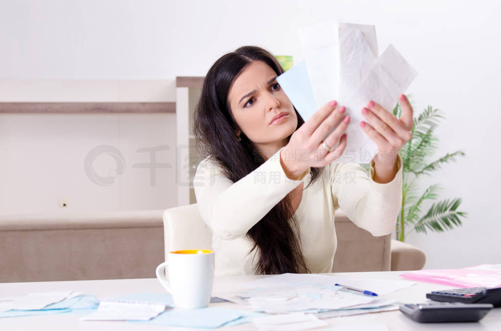 Young woman with receipts in budget planning concept