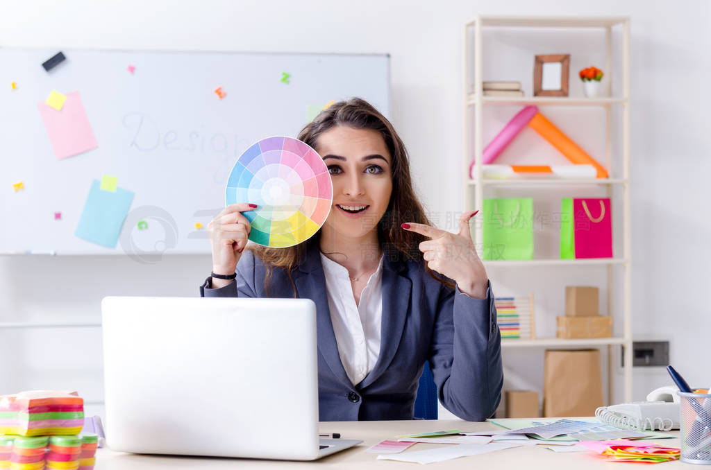 Young female designer working in the office