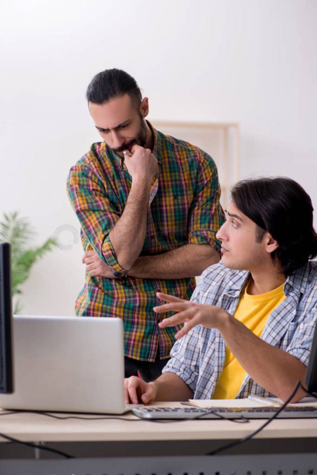 Two it specialists working in the office