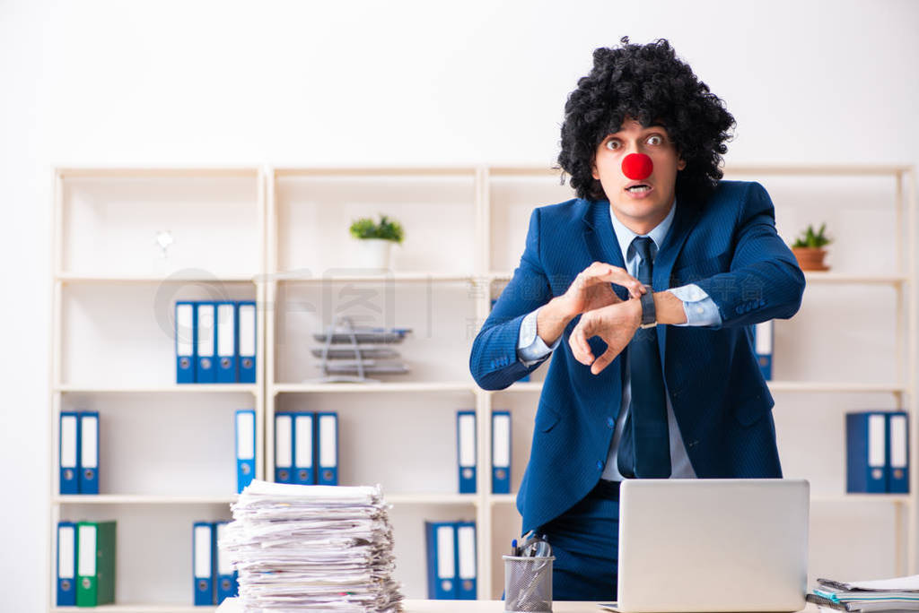 Young clown businessman working in the office