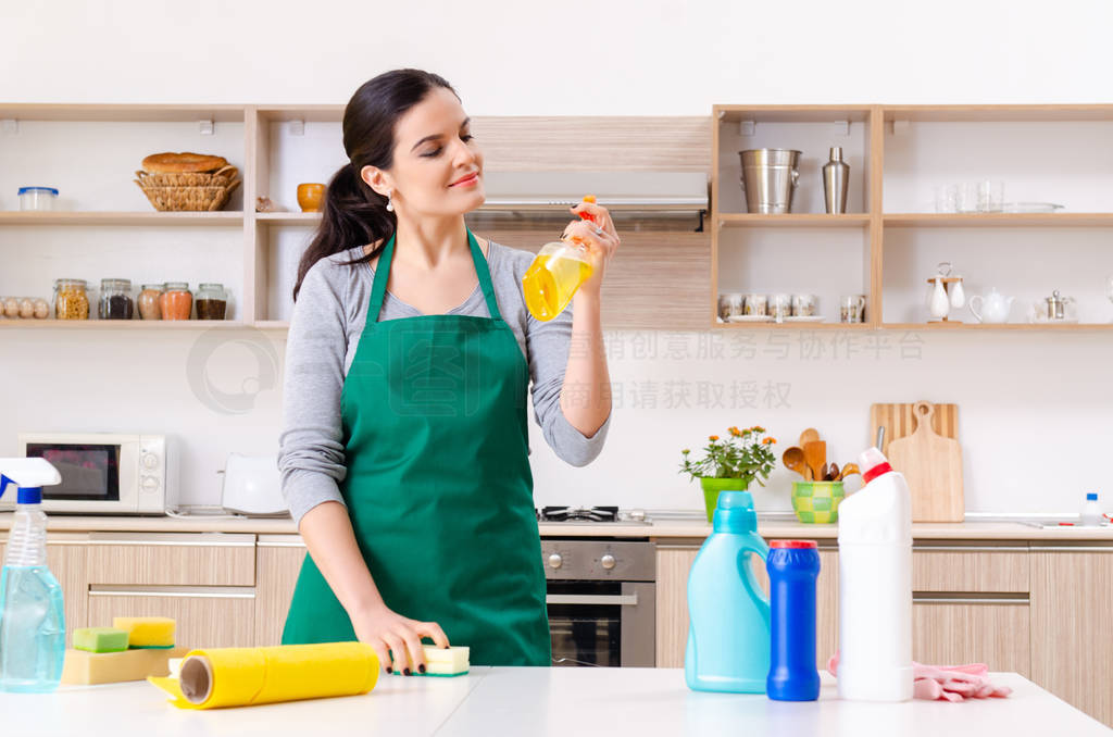 Young female contractor doing housework