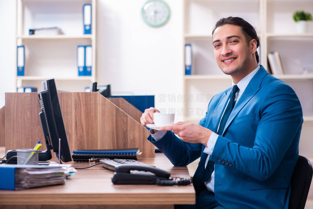 Young handsome businessman sitting in the office