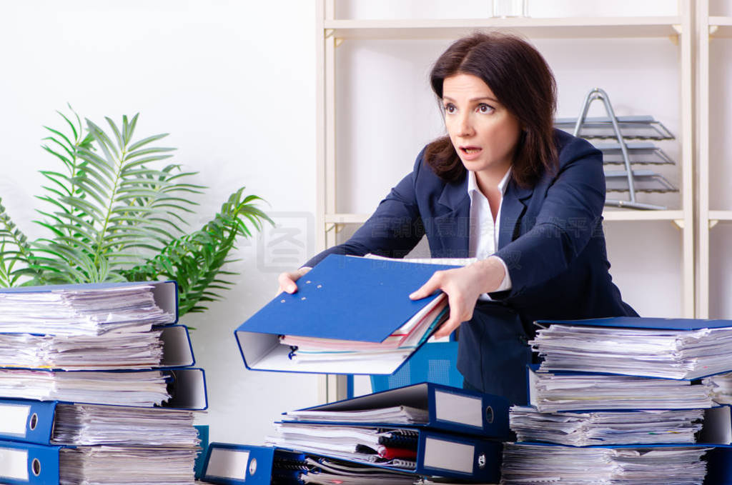 Middle-aged businesswoman unhappy with excessive work