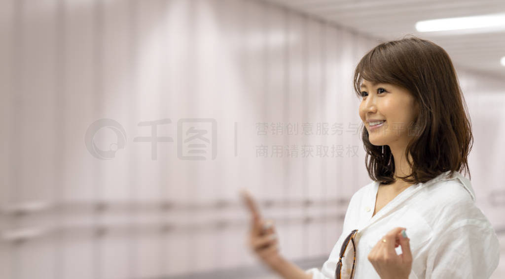 Young Asian businesswoman in the Hong Kong subway waiting for a